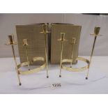 A pair of Swedish brass candleholders in original boxes.