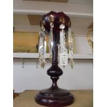 A Victorian ruby glass lustre with gold decoration, 33 cm tall.. COLLECT ONLY.