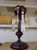 A Victorian ruby glass lustre with gold decoration, 33 cm tall.. COLLECT ONLY.