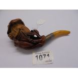 A vintage pipe featuring a nude figure.