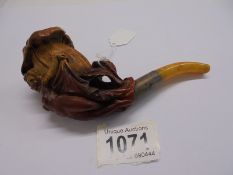 A vintage pipe featuring a nude figure.
