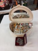 A jewellery box with a mixed lot of brooches and badges