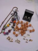 A quantity of colourful necklaces and cuff links including a pair of silver cuff links.
