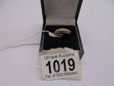 An 18ct gold five stone diamond ring, size P, 3.1 grams.