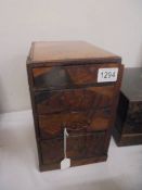 A table top four drawer inlaid chest a/f, 28cm high, 18cm wide adn 35cm deep.