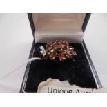 A 9ct gold red stone cluster ring, size Q half, 3.9 grams.