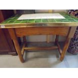 A pine kitchen table having a tiled top with brass edging, COLLECT ONLY.