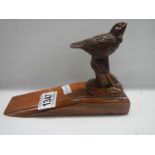 A carved bird doorstop, a/f (chipped).