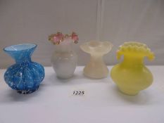 Four good old glass vases including blue overlaid and yellow frill top examples.