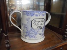 A large blue and white loving cup with frogs inside and inscribed 'George Booth Piper Lane Otley'.