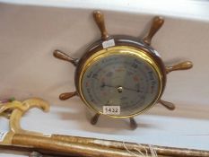 A ship's wheel style barometer.