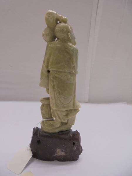 A Chinese soapstone figure of an elderly gentleman. - Image 4 of 4
