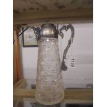 A hobnail cut glass claret jug with plated top and mask on spout.