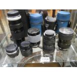 A quantity of cased camera lenses including Hoya, Super-Paragon, Olympus, Tokins, Sirius etc.,