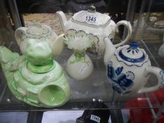 A Susie Cooper teapot a/f, three other teapots and a Belleek a/f vase.