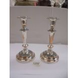 A pair of silver plate on copper candlesticks, 21cm, (plate worn)
