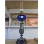 A Victorian spelter oil lamp with glass font. COLLECT ONLY.