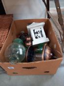 A box of garden decorative items including glass wasp trap etc