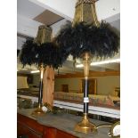 A pair of contemporary table lamps with feathered shades.