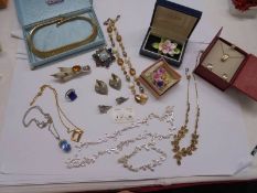 A mixed lot of costume jewellery including necklaces, earrings, brooches etc., (one necklace a/f).