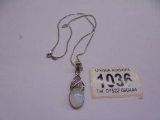 A silver pendant on silver chain, 6 grams.