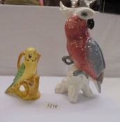 A Burleigh ware budgie jug and an un-marked parrot figure.