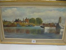 A framed oil on canvas river scene signed M L Woodcock, image 59 x 30 cm, frame 70 x 40 cm.