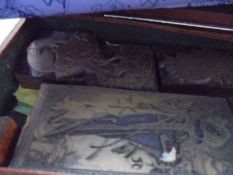 A quantity of old printing blocks in a wooden case.