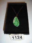 A jade pendant on a 9ct gold chain.