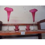A good pair of cranberry glass spill vases and a pair of small twin handled cranberry glass vases.