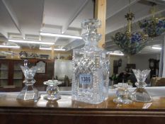 A cut glass decanter and two pairs of glass candleholders, COLLECT ONLY.