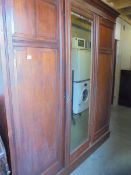 A mahogany triple door wardrobe, COLLECT ONLY.