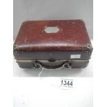 A small vintage suitcase/jewelry case.