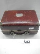 A small vintage suitcase/jewelry case.