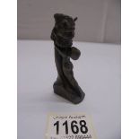 A small bronze art deco style lady holding Phallic symbol with loose bronze head of the devil.