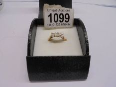 A three stone diamond ring (tests as 14ct gold) size N half, 2.86 grams.