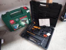A cased Bosch drill and cased power tack (missing charger pack)