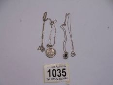 A silver St. Christopher and a silver pendant, 8 grams.