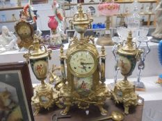 A three piece French clock set comprising ormolu and enamel clock with two sidepieces, COLLECT ONLY.
