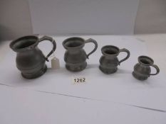 A set of four antique pewter measure, half pint, one gill, half gill and quarter gill.