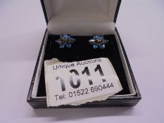 A pair of floral earrings marked 9ct.