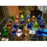 Approximately 25 small glass paperweights.