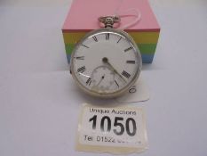 A silver pocket watch in working order but missing key.
