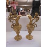 A pair of heavy gilt metal ewers (one a/f, crack to spout).