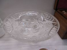A large cut glass bowl on three feet, 31.5CM diameter.