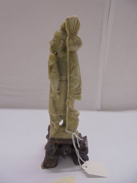 A Chinese soapstone figure of an elderly gentleman. - Image 3 of 4