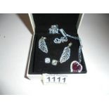 Three pairs of 'Pandora' silver earrings and a Swarovski crystal pendant.