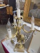 A candelabra style table lamp on cherub base, COLLECT ONLY.