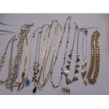 Ten white and yellow metal necklaces.