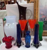A selection of coloured glass including a pair of spill vases etc